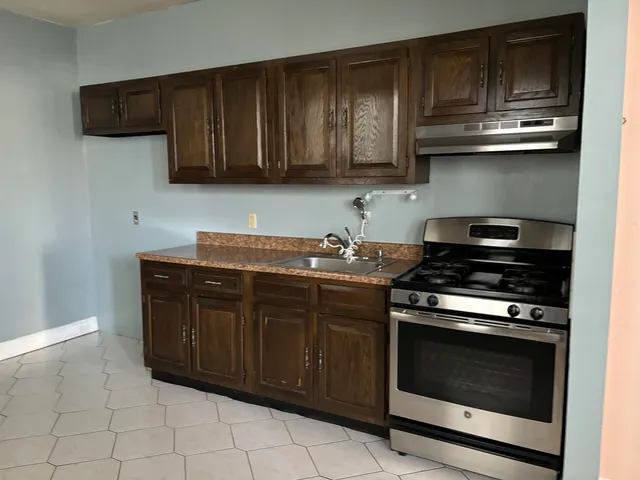 a stove top oven sitting inside of a kitchen
