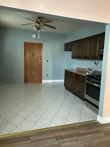 a kitchen with stainless steel appliances granite countertop a stove a sink and a refrigerator