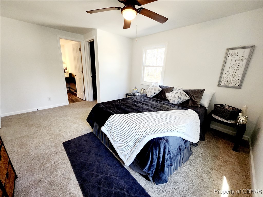 10766 Figg Shop Road Gloucester, VA 23061 - Photo 12 of 24 Primary Bedroom with new carpet and ceiling fan featuring huge walk in closet