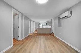 a view of a room with wooden floor and window