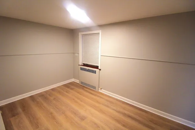an empty room with wooden floor