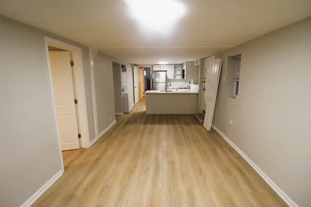 a view of room with window and wooden floor