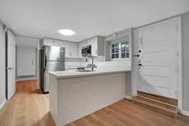 a kitchen with stainless steel appliances granite countertop a refrigerator and a sink