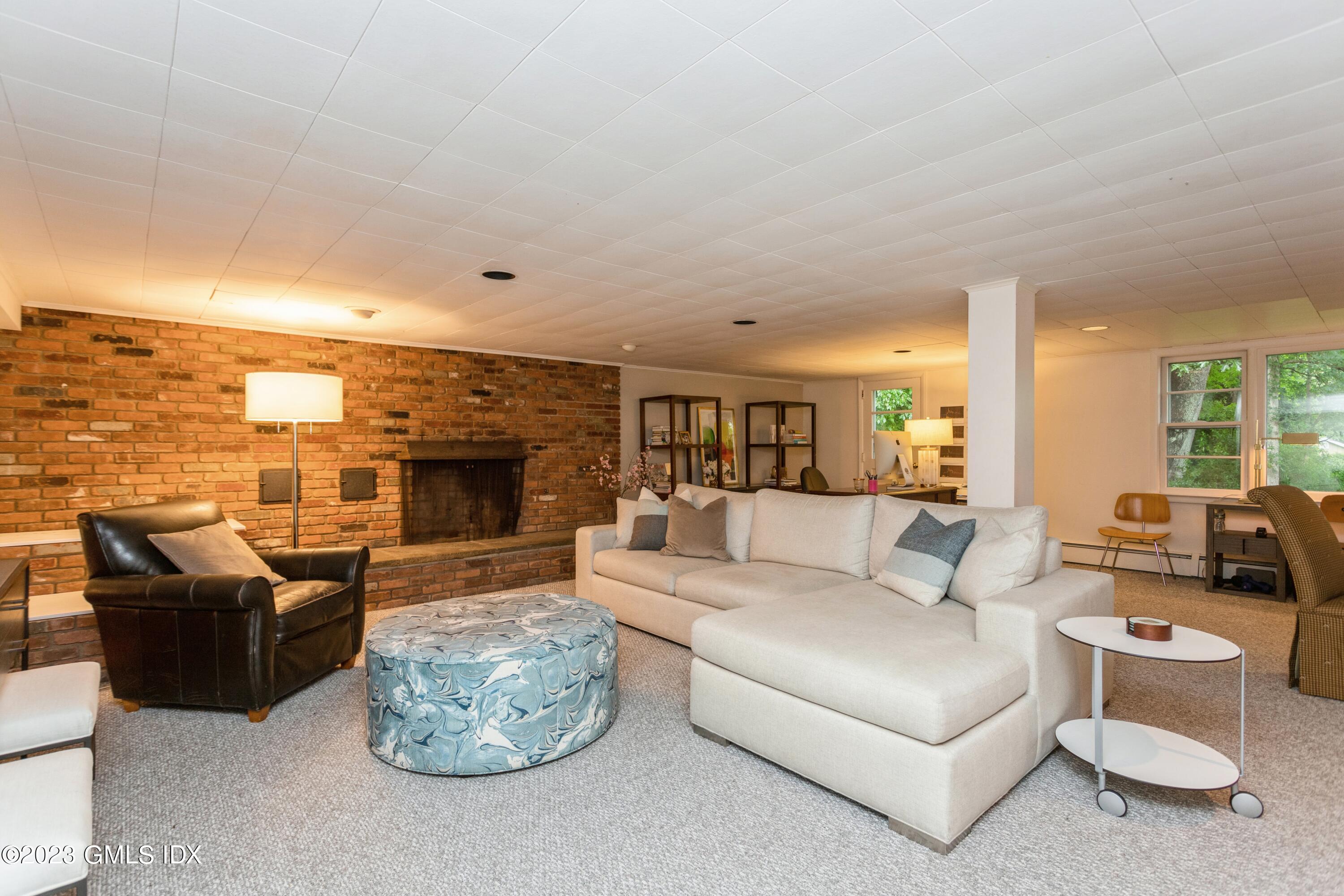 29 Dandy Drive Cos Cob, CT 06807 - Photo 11 of 17 a living room with furniture fireplace and a flat screen tv