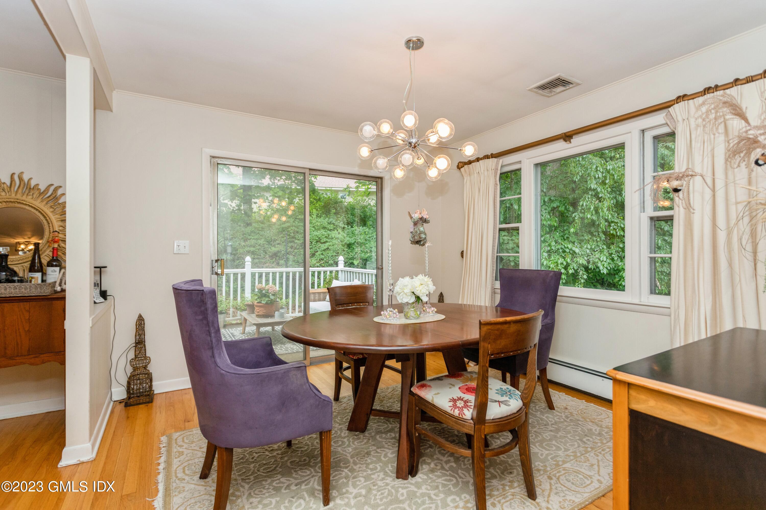 29 Dandy Drive Cos Cob, CT 06807 - Photo 4 of 17 a view of a dining room with furniture a chandelier and wooden floor