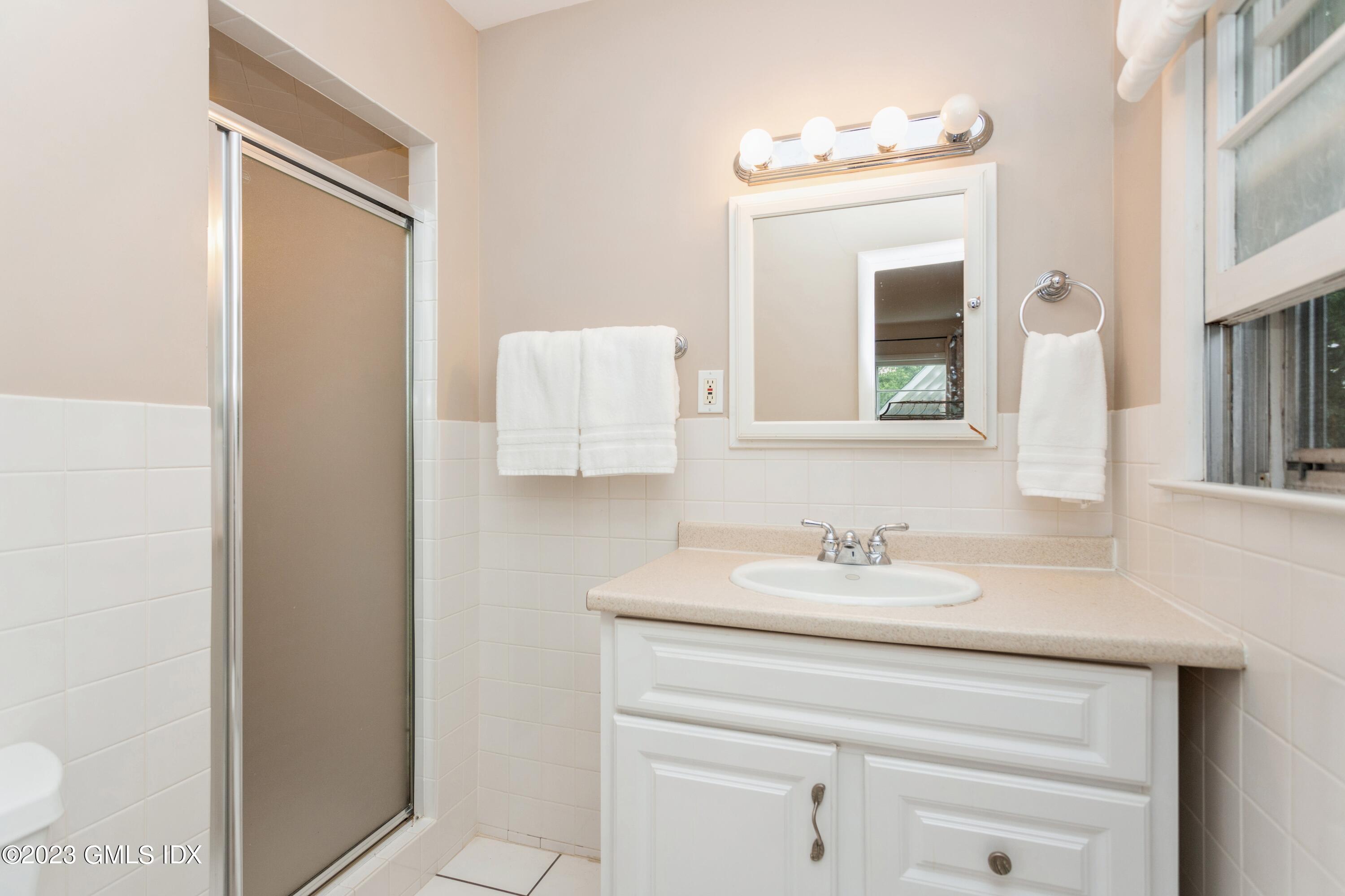 29 Dandy Drive Cos Cob, CT 06807 - Photo 7 of 17 a bathroom with a sink and a mirror