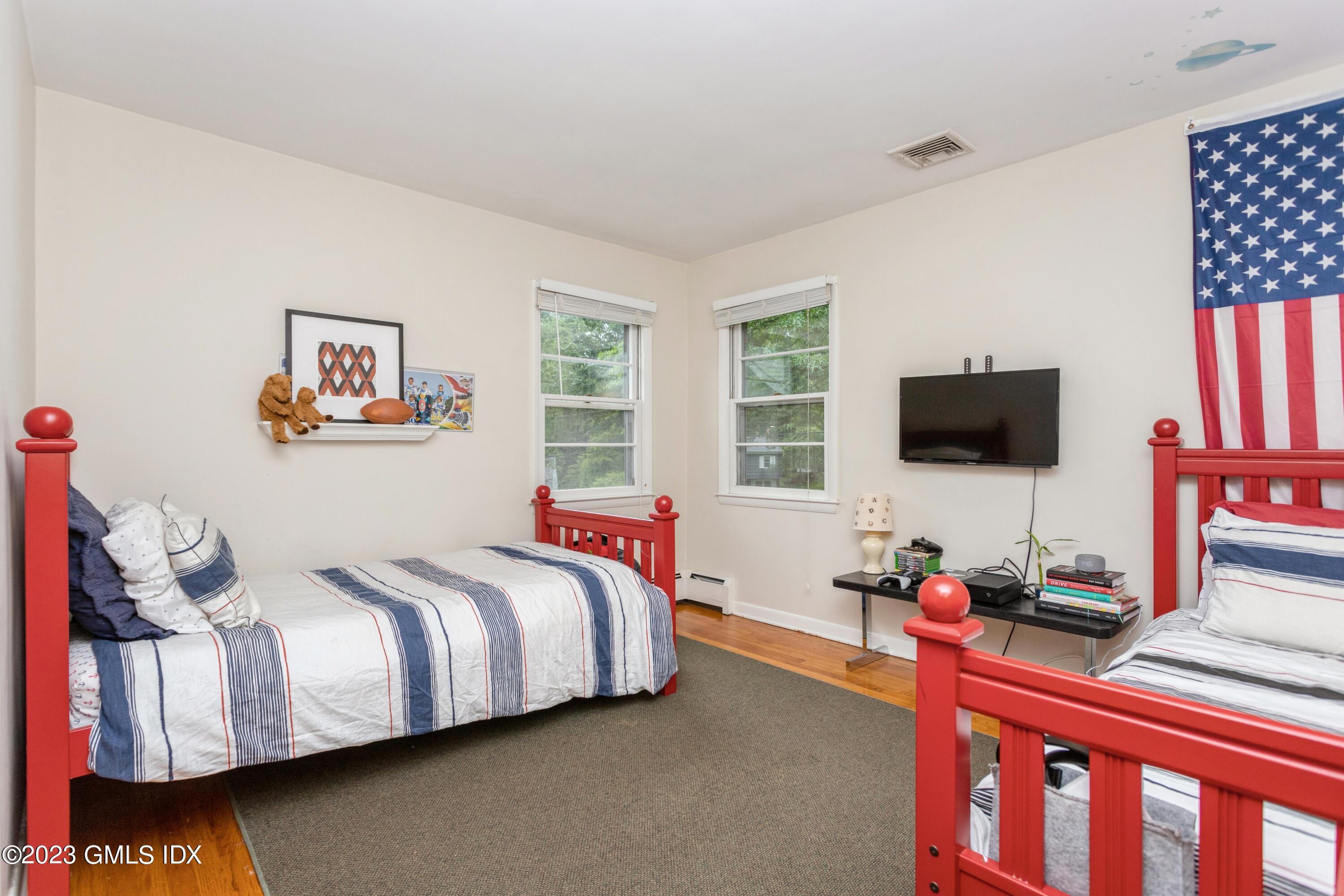 29 Dandy Drive Cos Cob, CT 06807 - Photo 8 of 17 a bedroom with a bed and flat screen tv