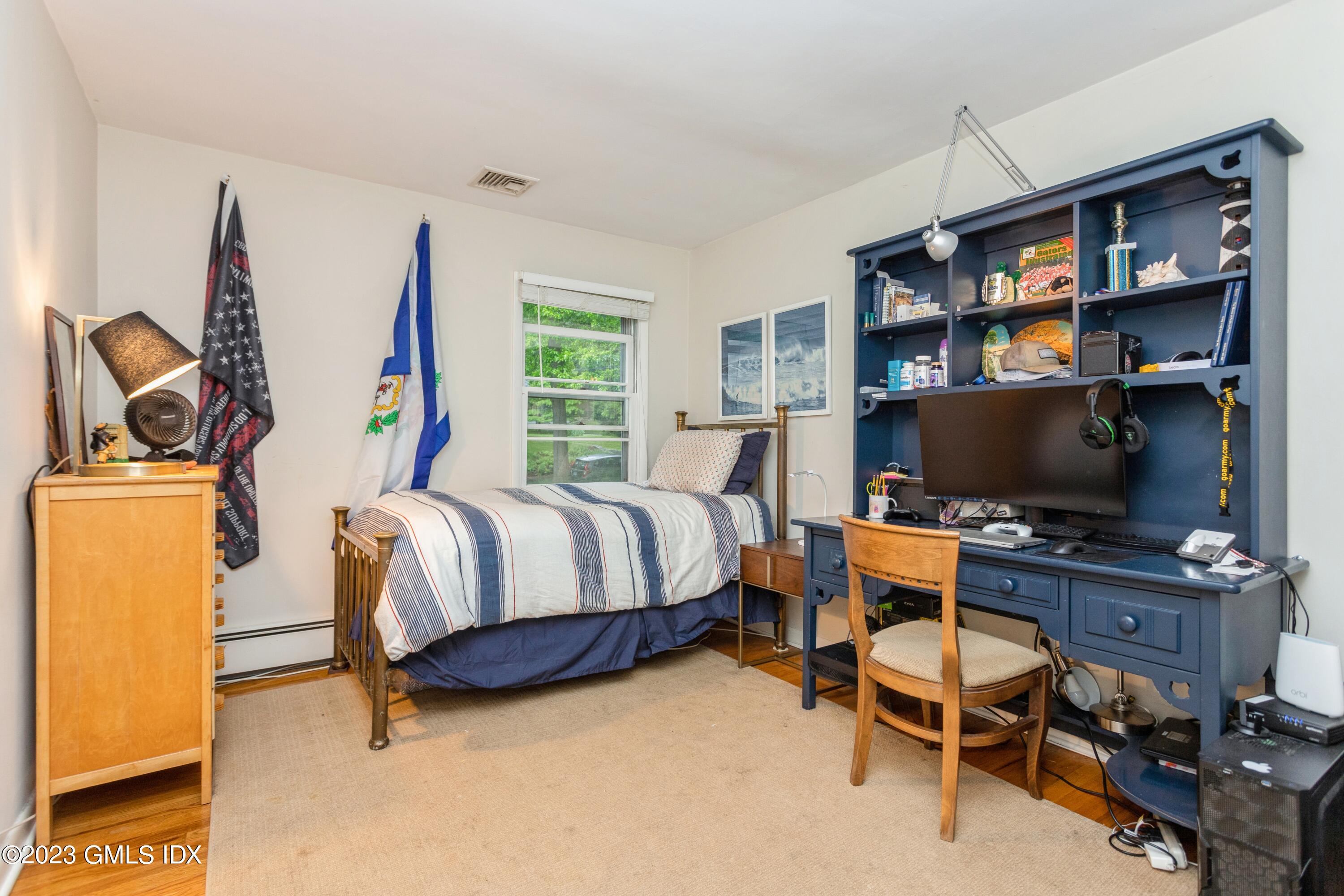 29 Dandy Drive Cos Cob, CT 06807 - Photo 9 of 17 a bedroom with a bed and a flat screen tv