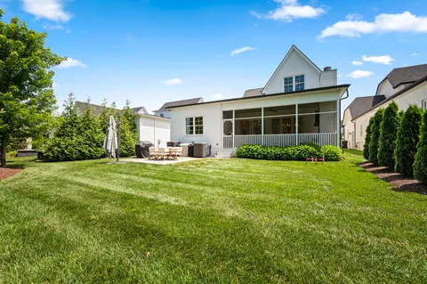 a view of a house with backyard and a patio