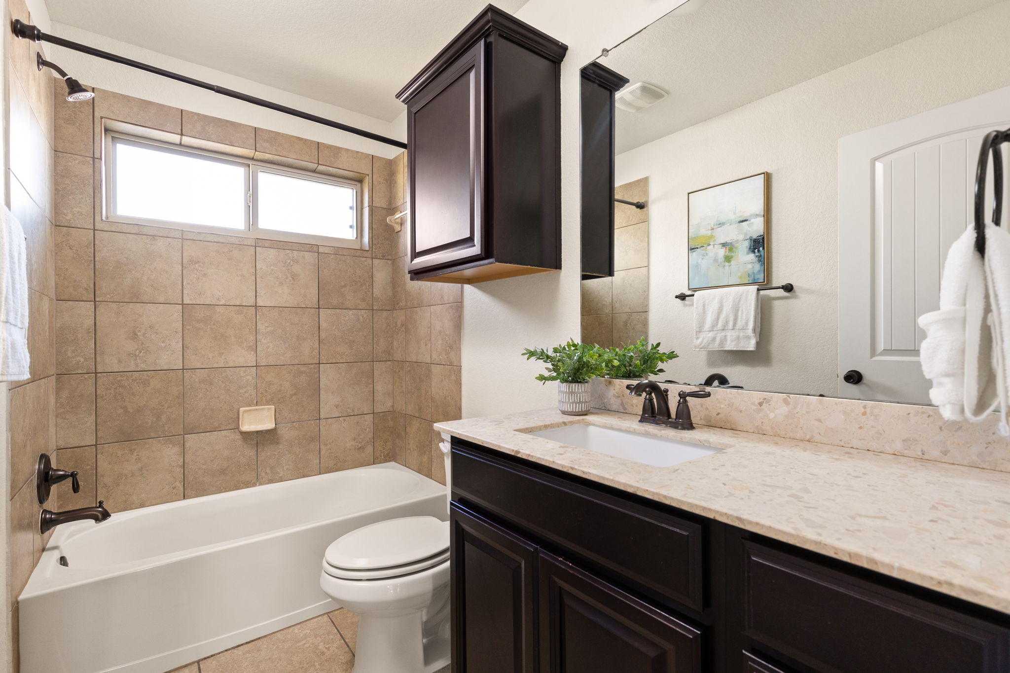 2400 Leonards Pass Leander, TX 78641 - Photo 33 of 40 Elegant dark cabinetry complements light counters in this well-appointed bathroom.