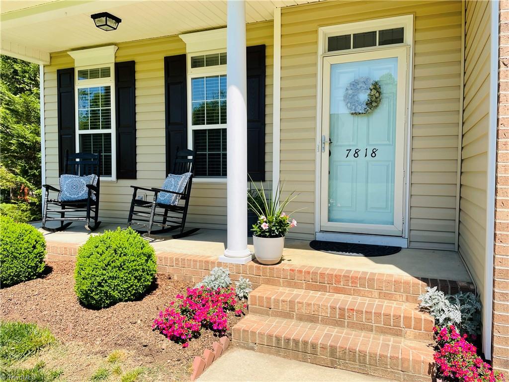7818 Wilson Farm Road Summerfield, NC 27358 - Photo 2 of 50 The perfect covered front porch, well manicured yard.