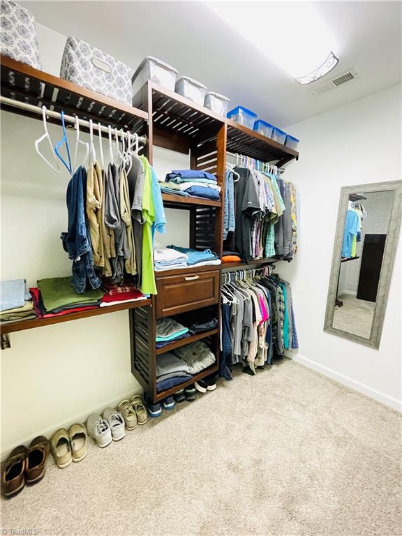 7818 Wilson Farm Road Summerfield, NC 27358 - Photo 24 of 50 Primary bedroom closet with upgraded shelving