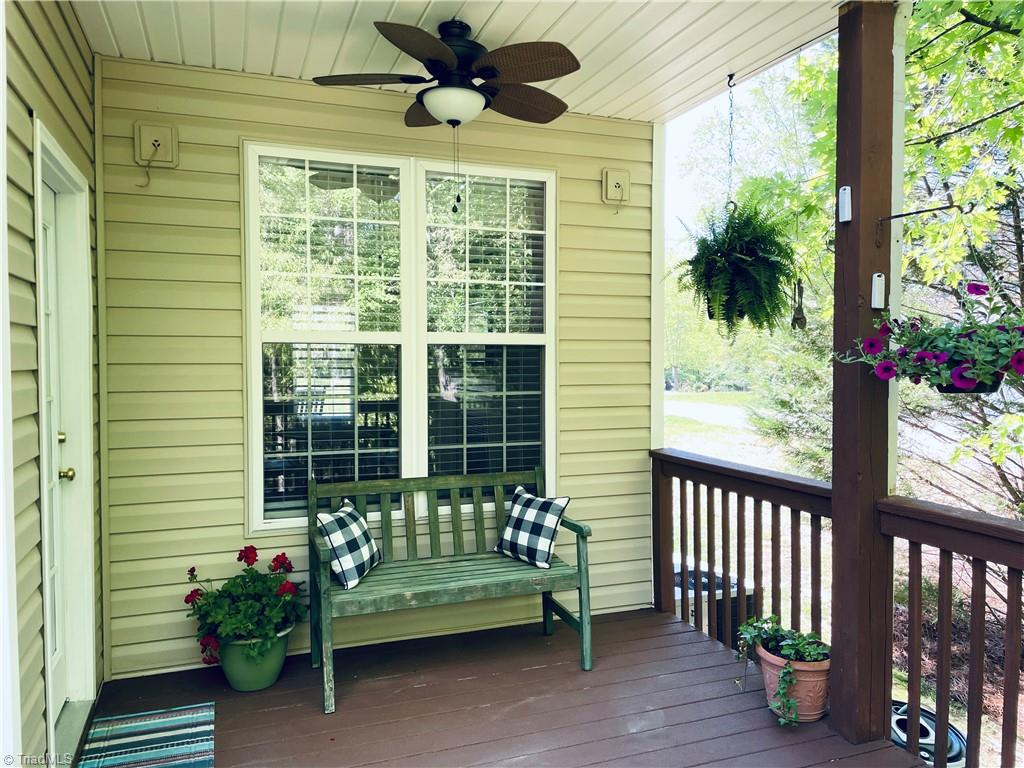 7818 Wilson Farm Road Summerfield, NC 27358 - Photo 4 of 50 Cozy covered sitting area with ceiling fan