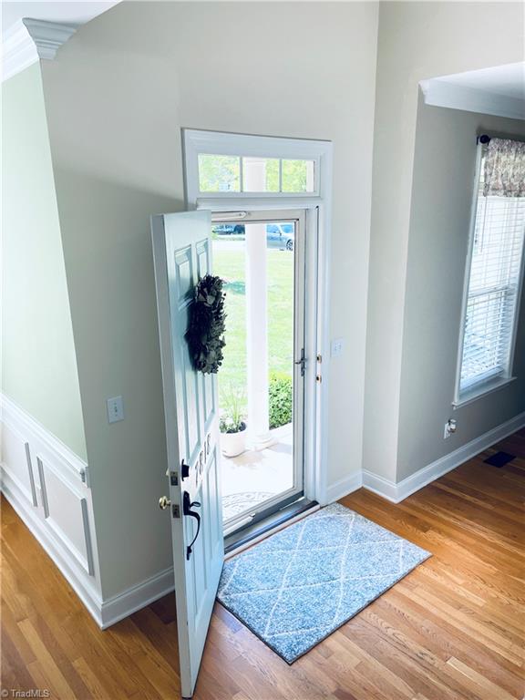 7818 Wilson Farm Road Summerfield, NC 27358 - Photo 6 of 50 Storm front door, lets in plenty of light. Hardwood floors throughout on main level.