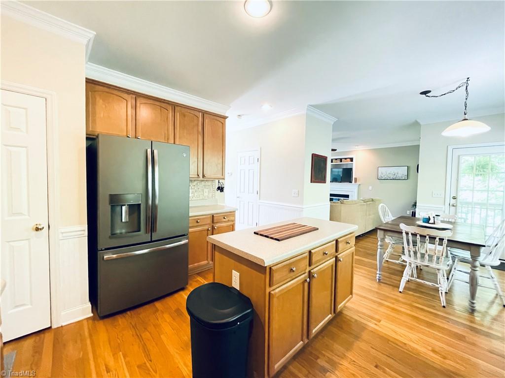 7818 Wilson Farm Road Summerfield, NC 27358 - Photo 10 of 50 Kitchen open to breakfast area and living room. Hardwood floors on main