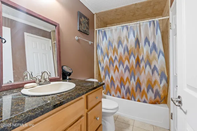 a bedroom with a bed and large windows