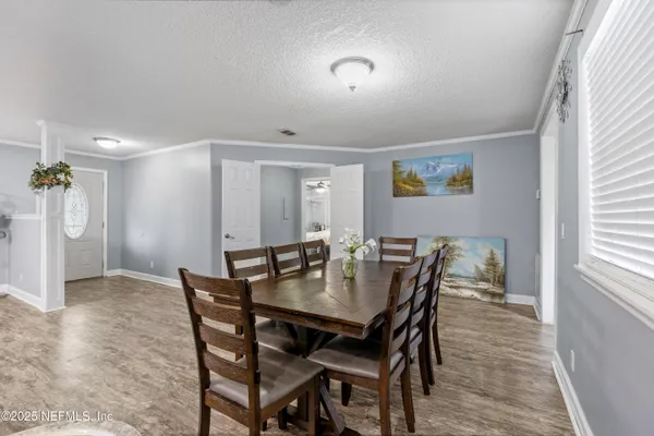 a kitchen with granite countertop a stove top oven a sink dishwasher a refrigerator cabinets and wooden floor