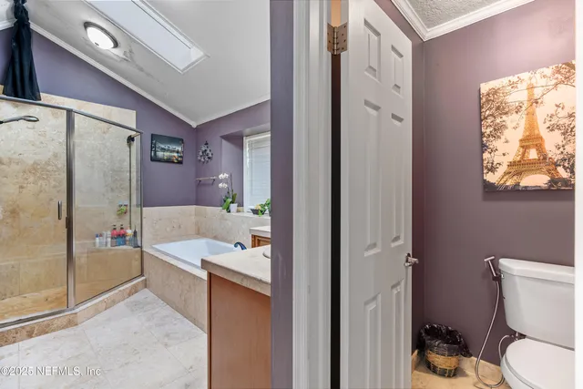 a bedroom with a large bed chandelier and a window