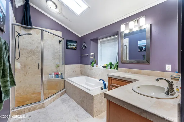 a spacious bedroom with a bed and a flat screen tv