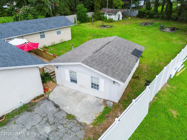 an aerial view of residential houses with outdoor space and street view