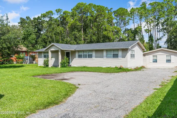 a view of a backyard with sitting area