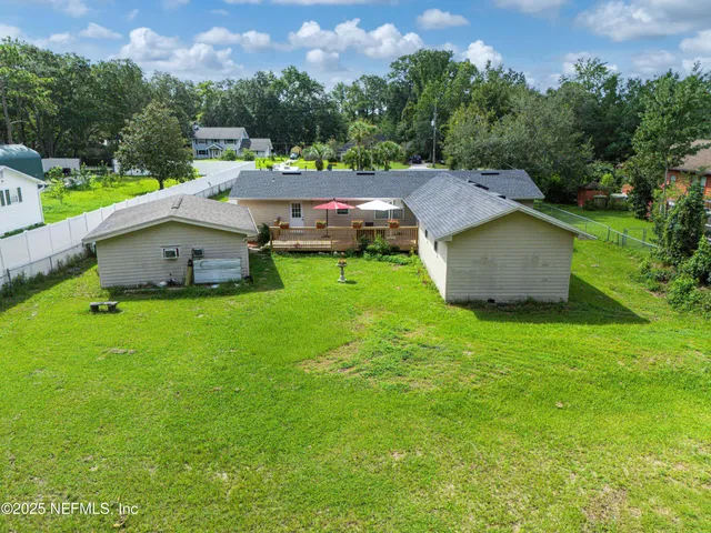 an aerial view of a house with a yard