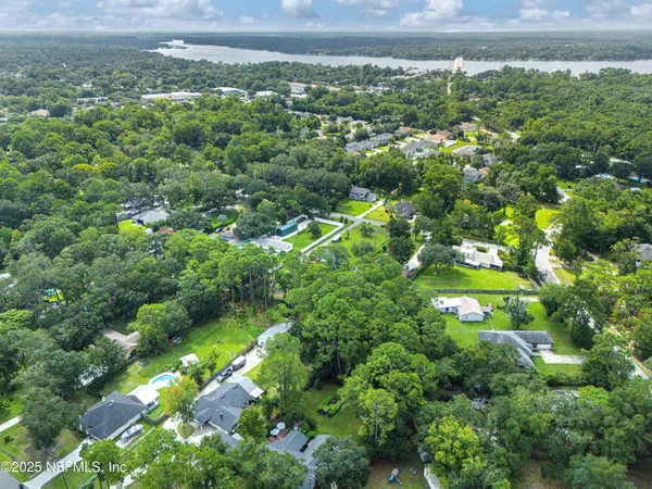 a view of a lake with a house in a back yard