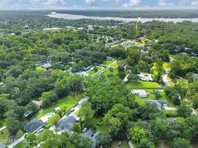 a view of a lake with a house in a back yard