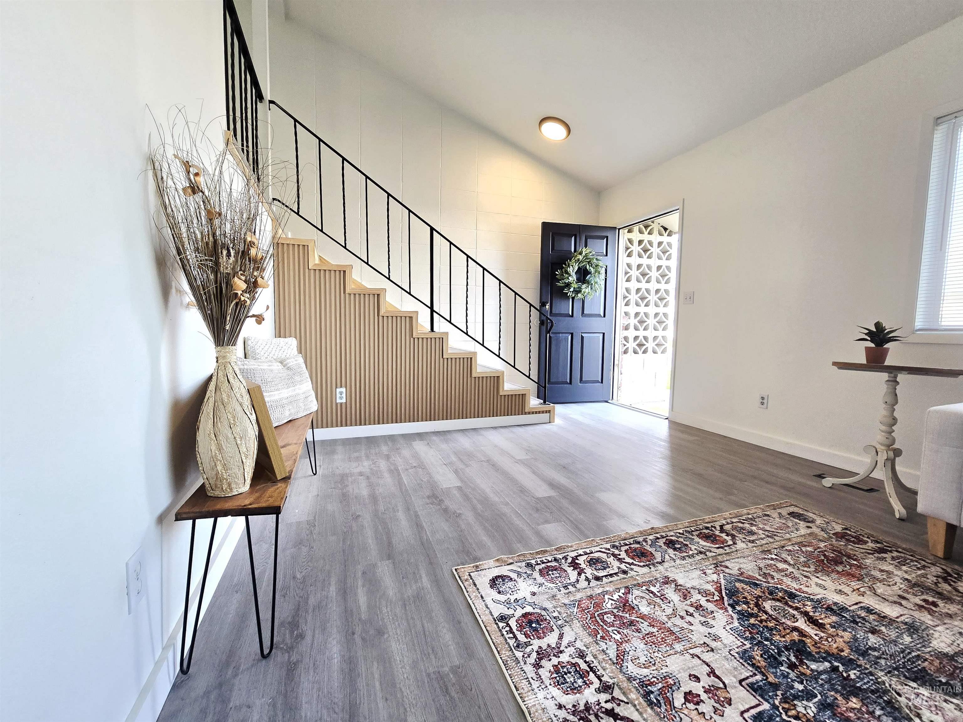 728 Northwest 8th Street Meridian, ID 83642 - Photo 4 of 18 Entryway with light wood-type flooring and lofted ceiling