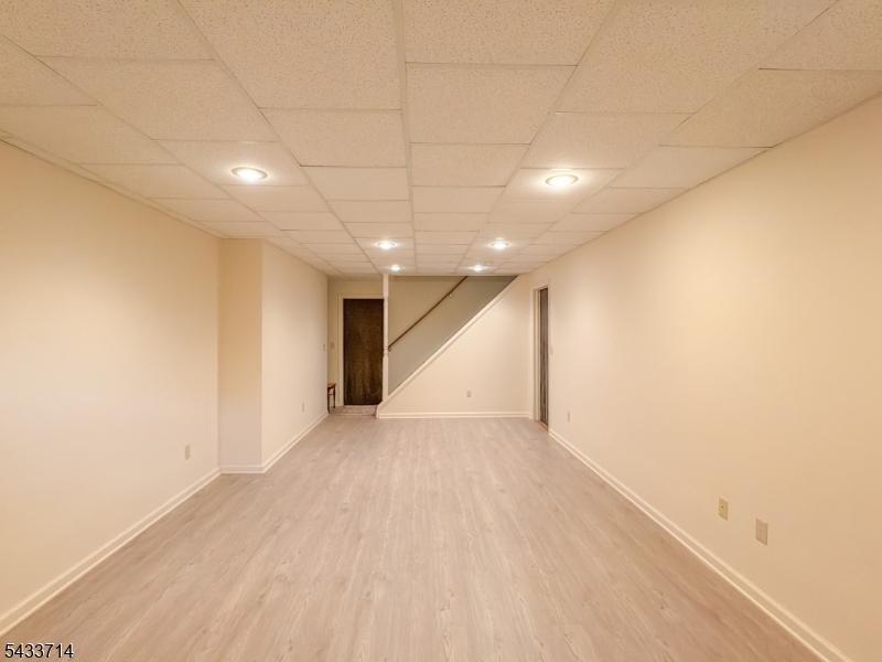 29 Lark Lane Oak Ridge, NJ 07438 - Photo 25 of 26 an empty room with wooden floor and windows