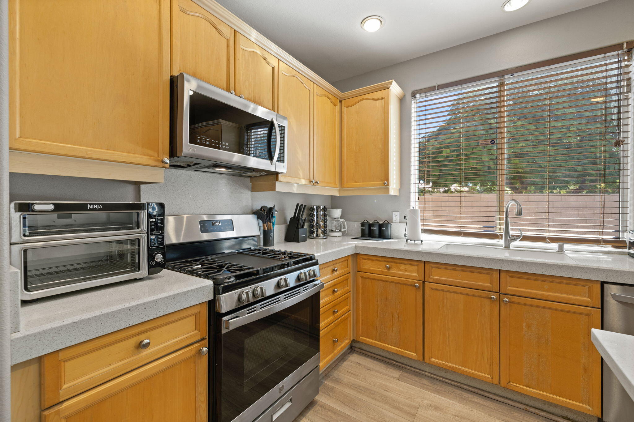 80759 Avery Drive Indio, CA 92201 - Photo 11 of 70 a kitchen with stainless steel appliances granite countertop a stove and a microwave