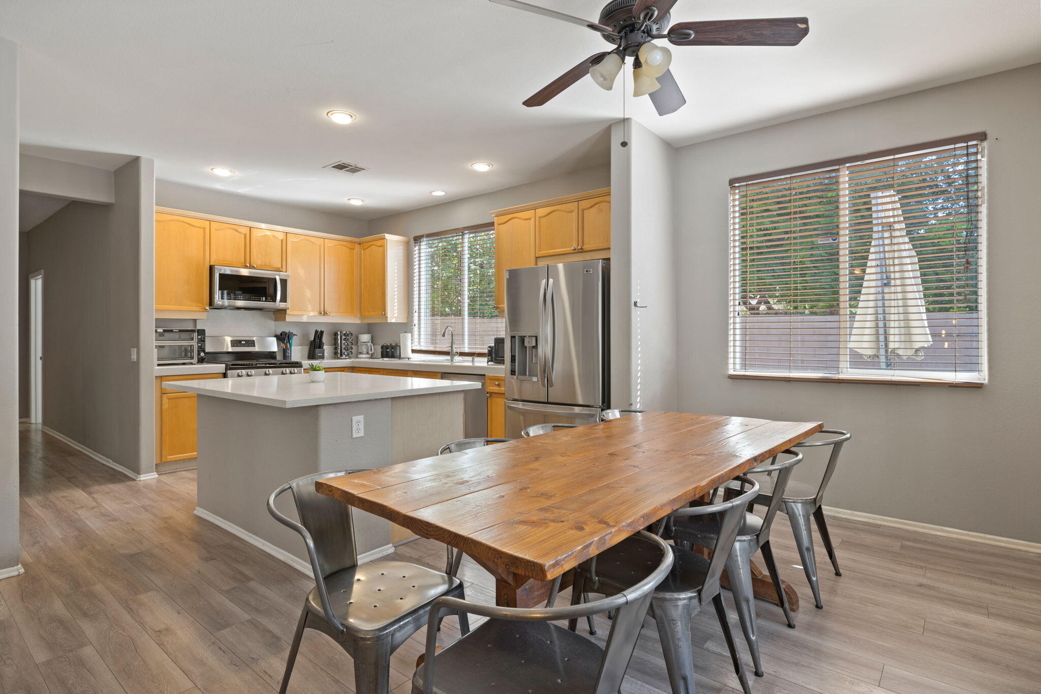 80759 Avery Drive Indio, CA 92201 - Photo 15 of 70 a kitchen with a table chairs refrigerator and microwave