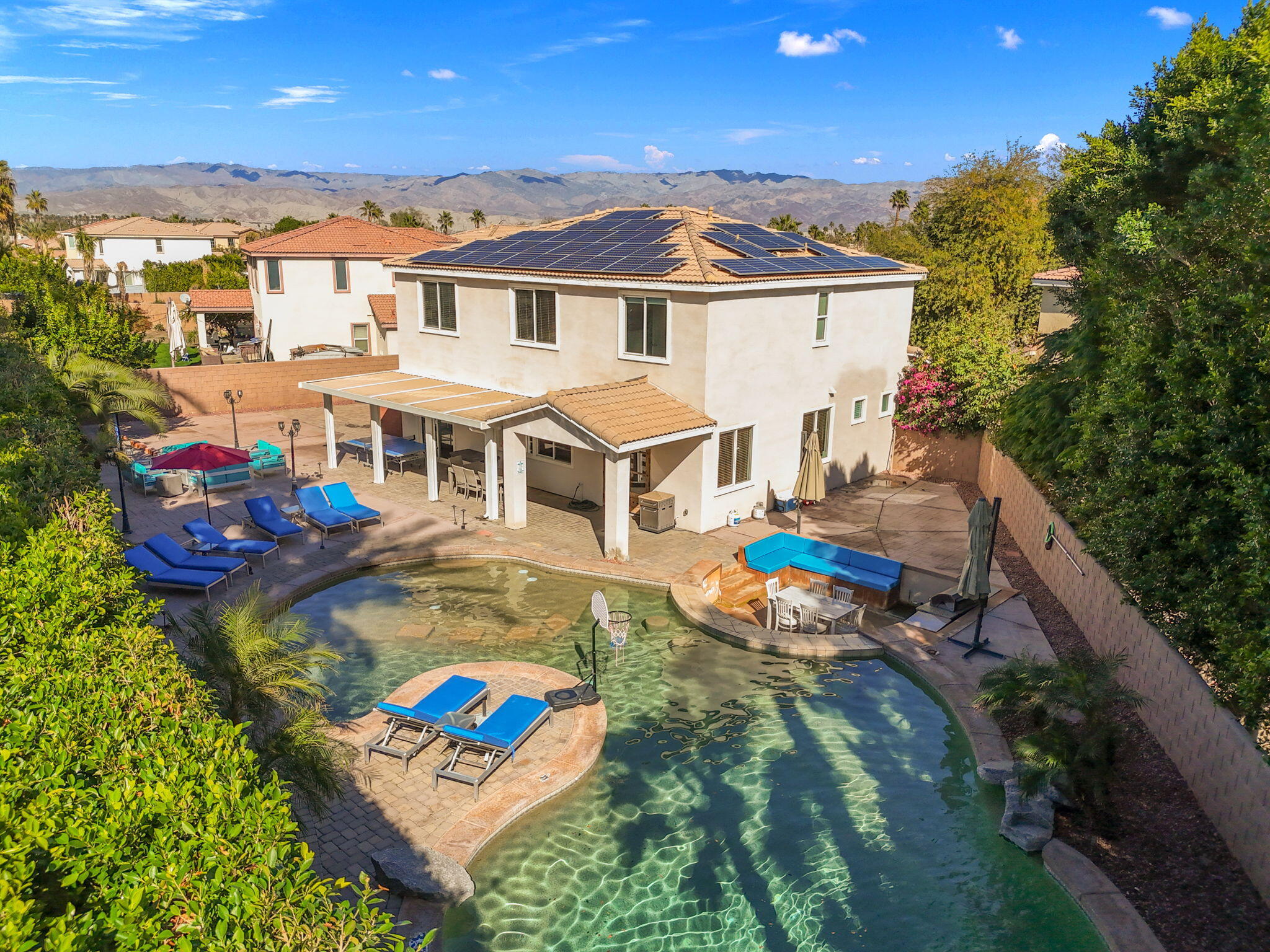 80759 Avery Drive Indio, CA 92201 - Photo 47 of 70 a view of a patio with couches table and chairs with wooden floor and fence