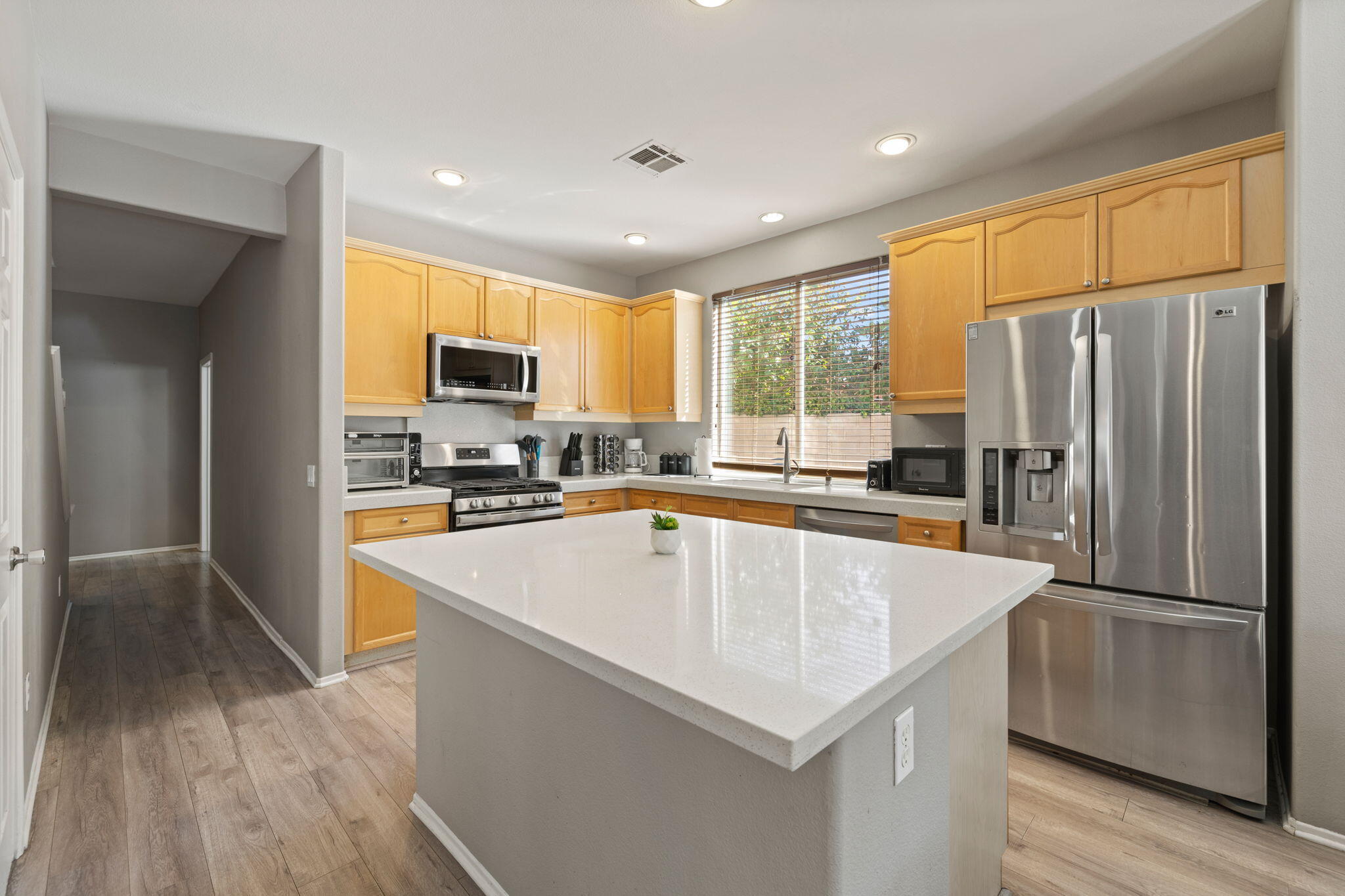80759 Avery Drive Indio, CA 92201 - Photo 10 of 70 a kitchen with stainless steel appliances a refrigerator a stove a sink a center island and a refrigerator