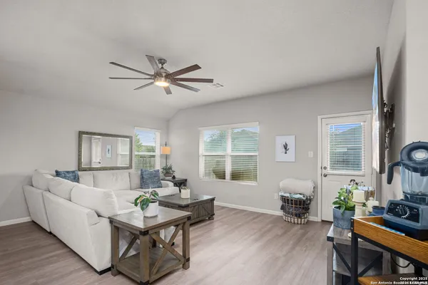 a living room with furniture and wooden floor