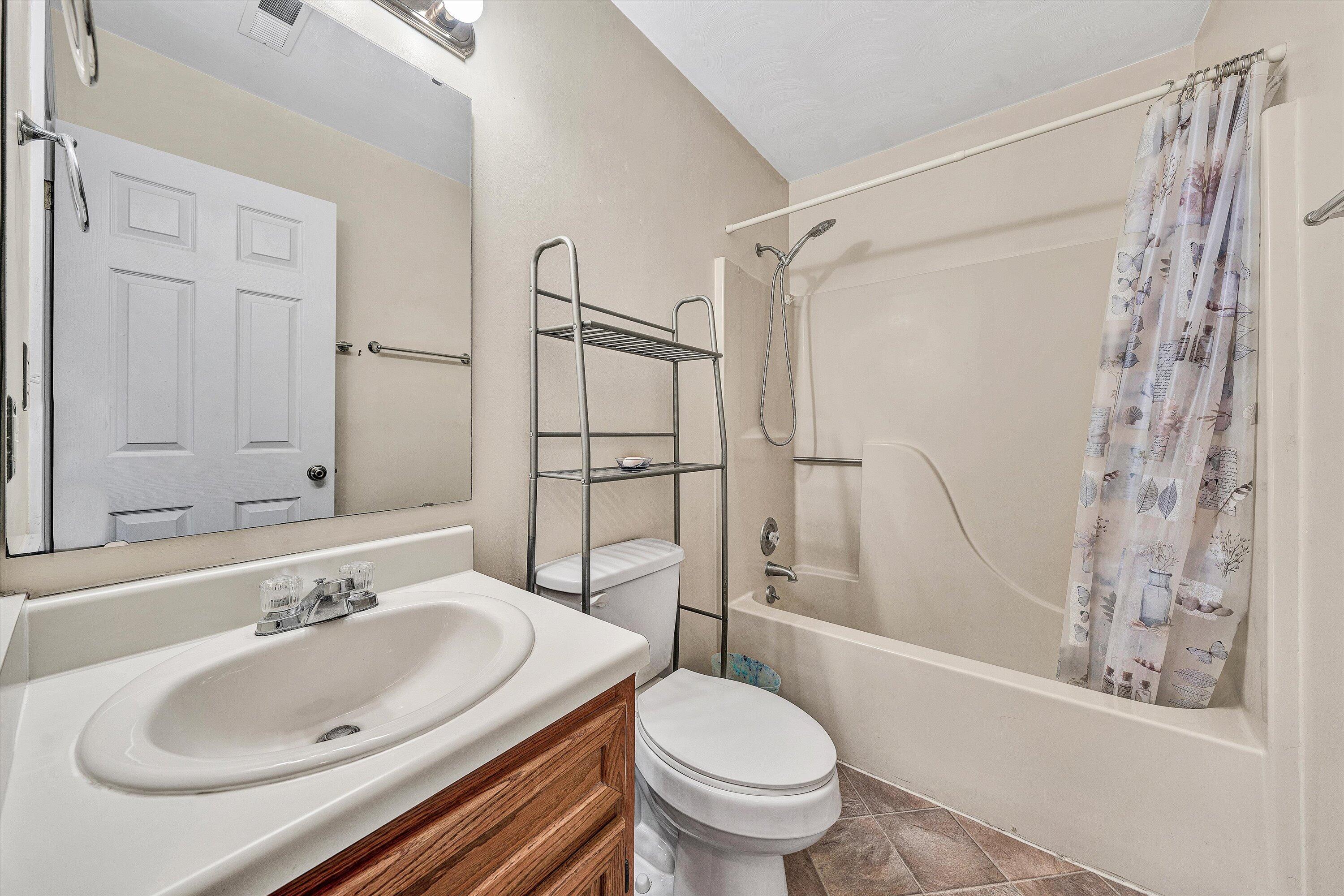 1060 Kessler Mill Road Salem, VA 24153 - Photo 13 of 31 a bathroom with a sink toilet and shower