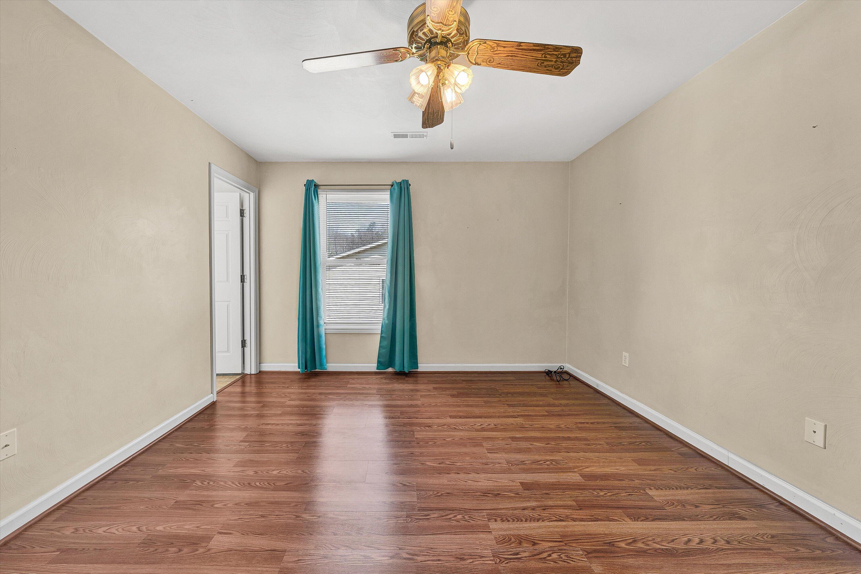 1060 Kessler Mill Road Salem, VA 24153 - Photo 14 of 31 a view of an empty room with window and wooden floor