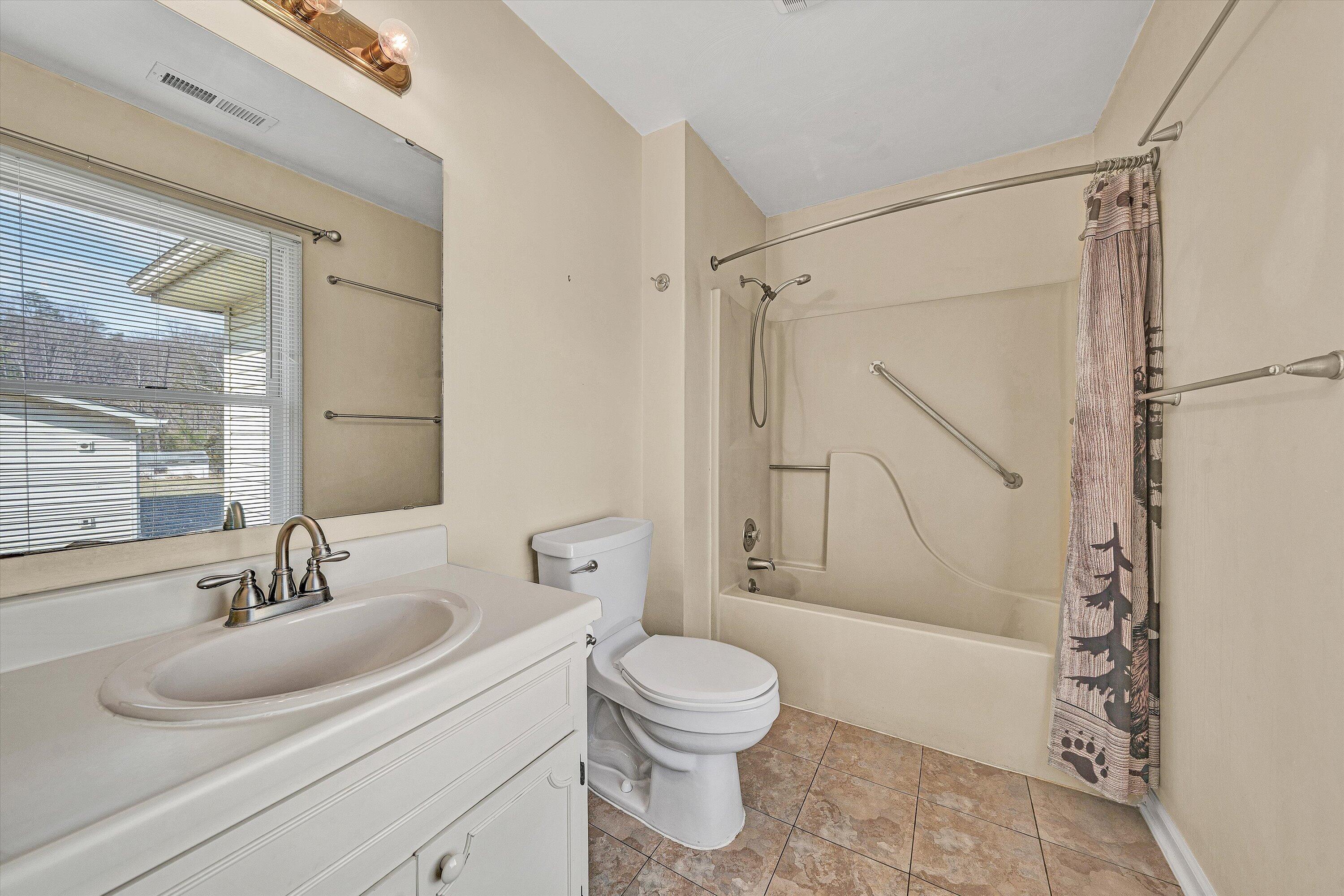 1060 Kessler Mill Road Salem, VA 24153 - Photo 16 of 31 a bathroom with a sink toilet and shower