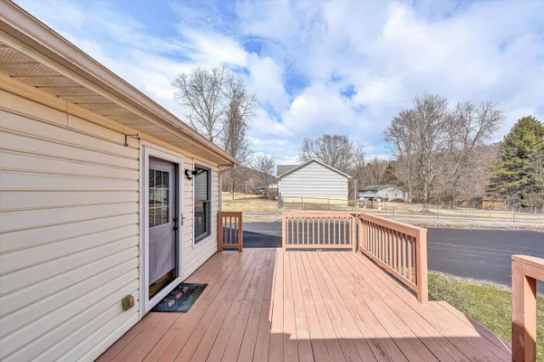 a view of a house with wooden deck