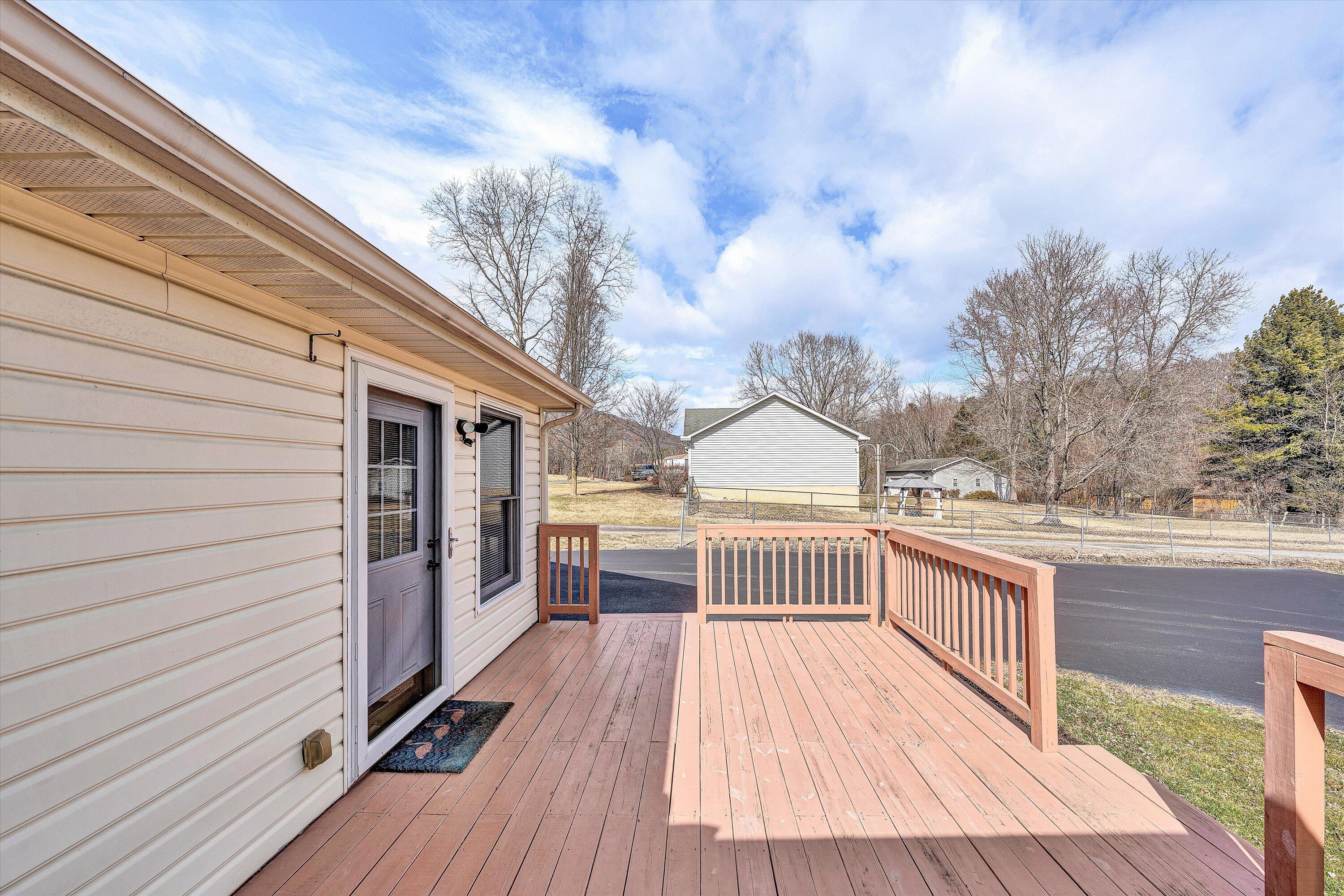 1060 Kessler Mill Road Salem, VA 24153 - Photo 18 of 31 a view of a roof deck with wooden floor and fence