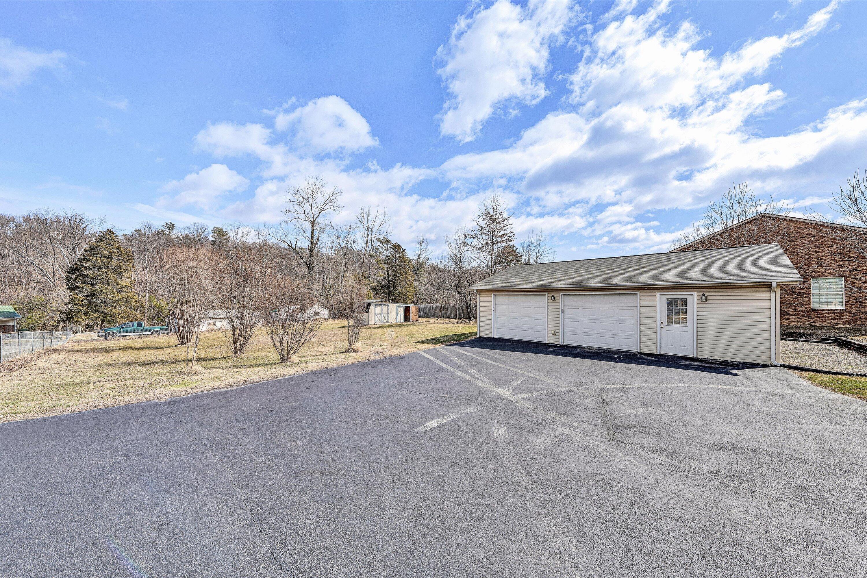 1060 Kessler Mill Road Salem, VA 24153 - Photo 27 of 31 a view of a house with a yard and a large tree