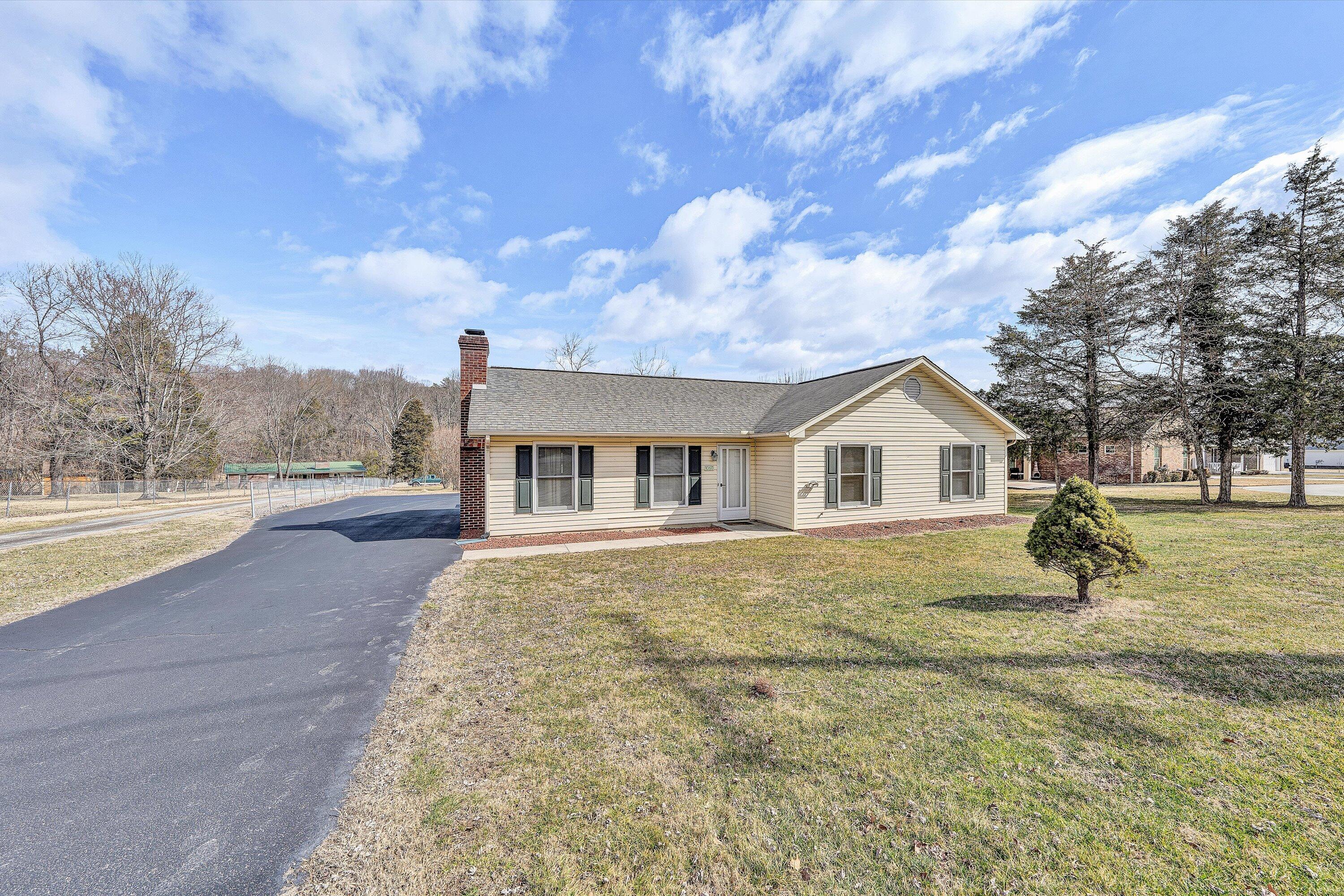 1060 Kessler Mill Road Salem, VA 24153 - Photo 29 of 31 a front view of a house with a yard and trees