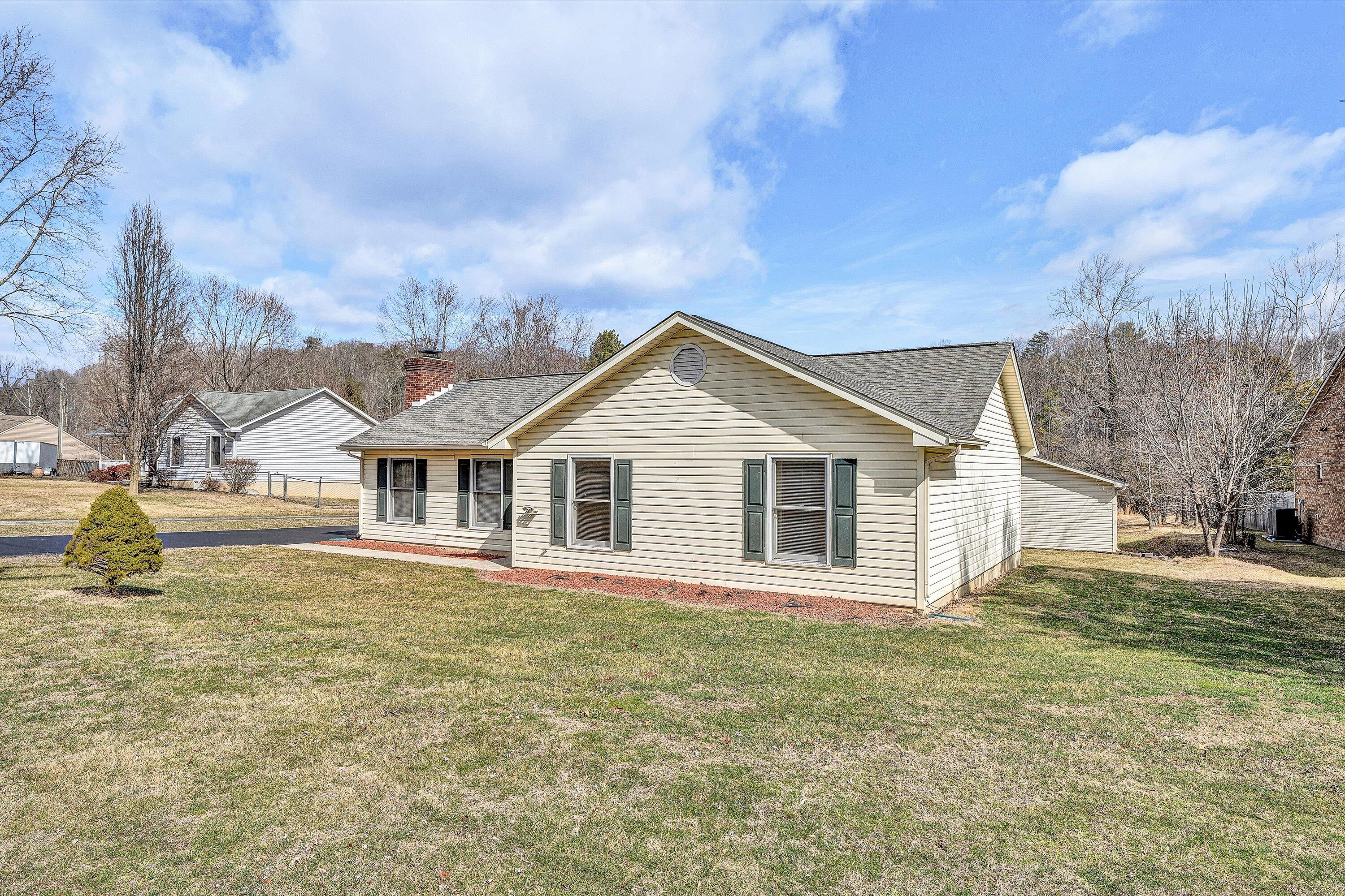1060 Kessler Mill Road Salem, VA 24153 - Photo 30 of 31 a front view of a house with a garden and yard