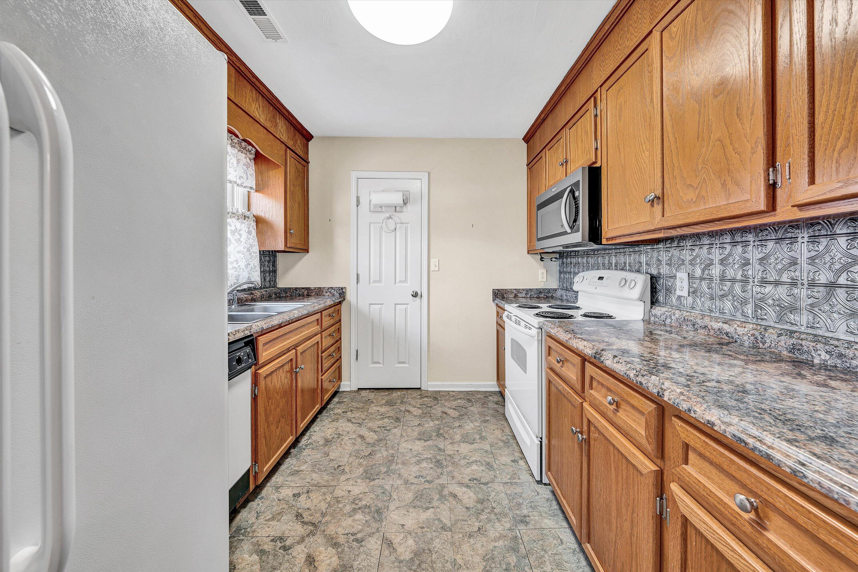 1060 Kessler Mill Road Salem, VA 24153 - Photo 6 of 31 a large kitchen with stainless steel appliances granite countertop a stove a sink and a refrigerator