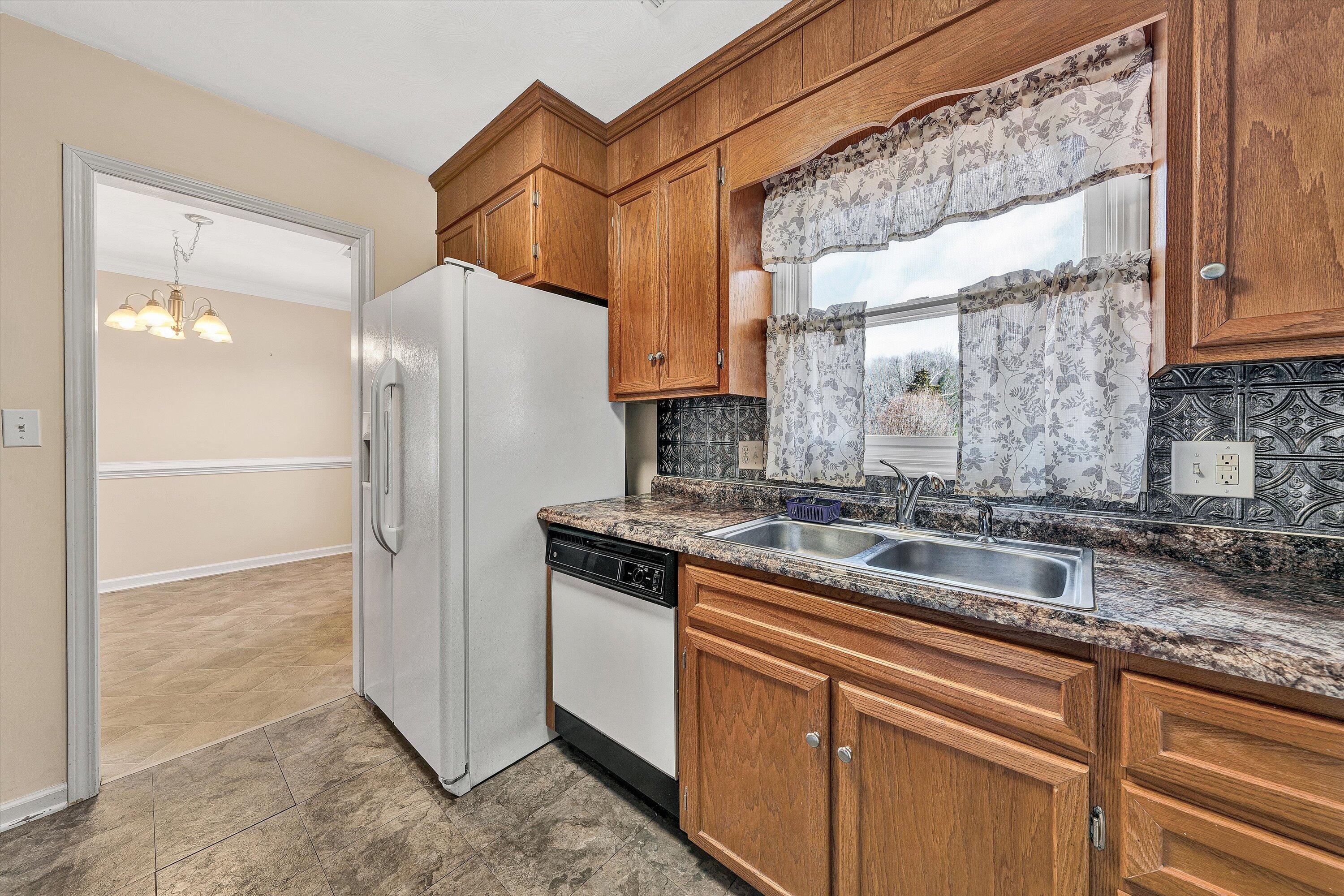 1060 Kessler Mill Road Salem, VA 24153 - Photo 7 of 31 a kitchen with stainless steel appliances granite countertop a refrigerator and a sink