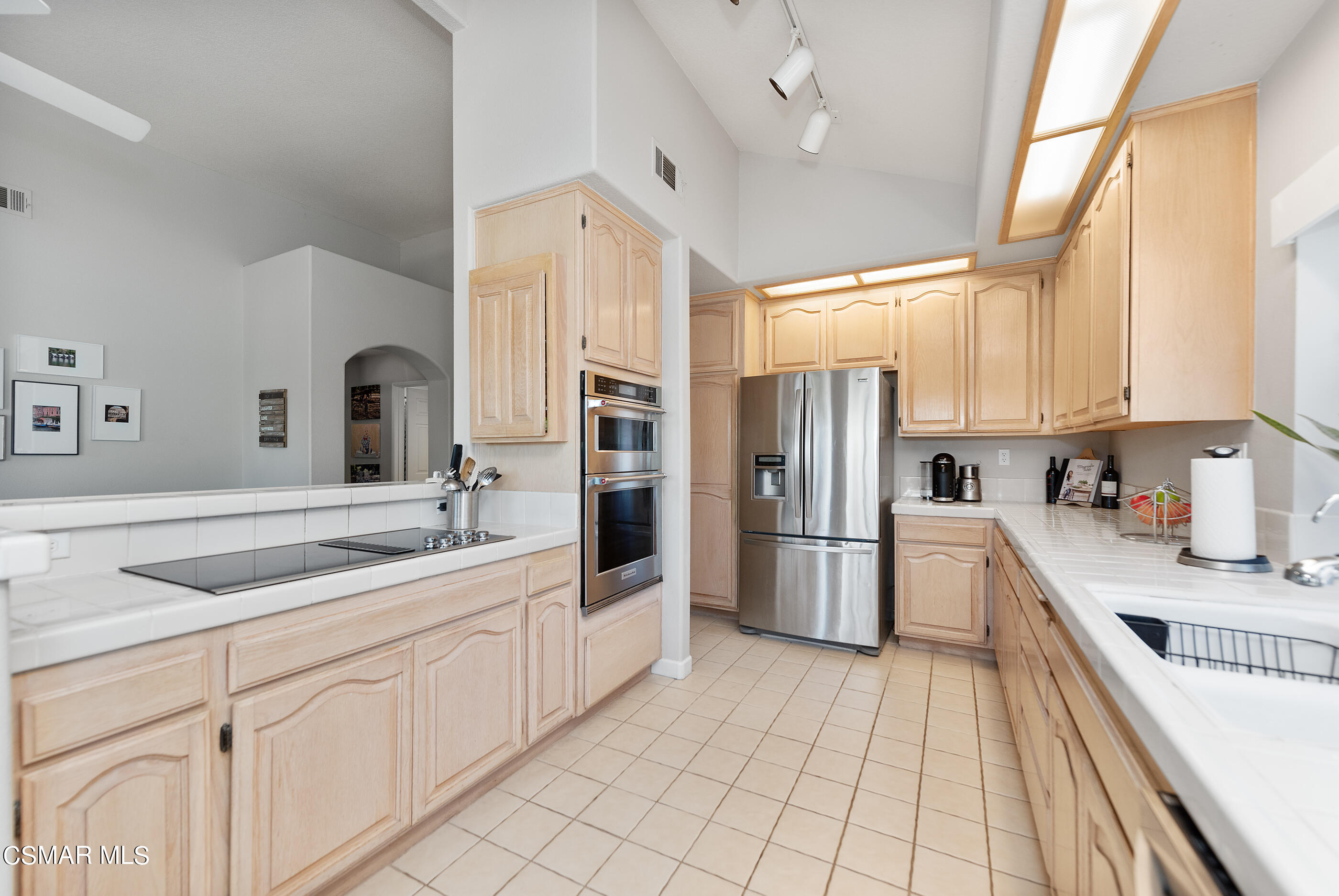 472 Fresh Meadows Road Simi Valley, CA 93065 - Photo 15 of 33 a kitchen with a sink dishwasher a refrigerator and cabinets with wooden floor