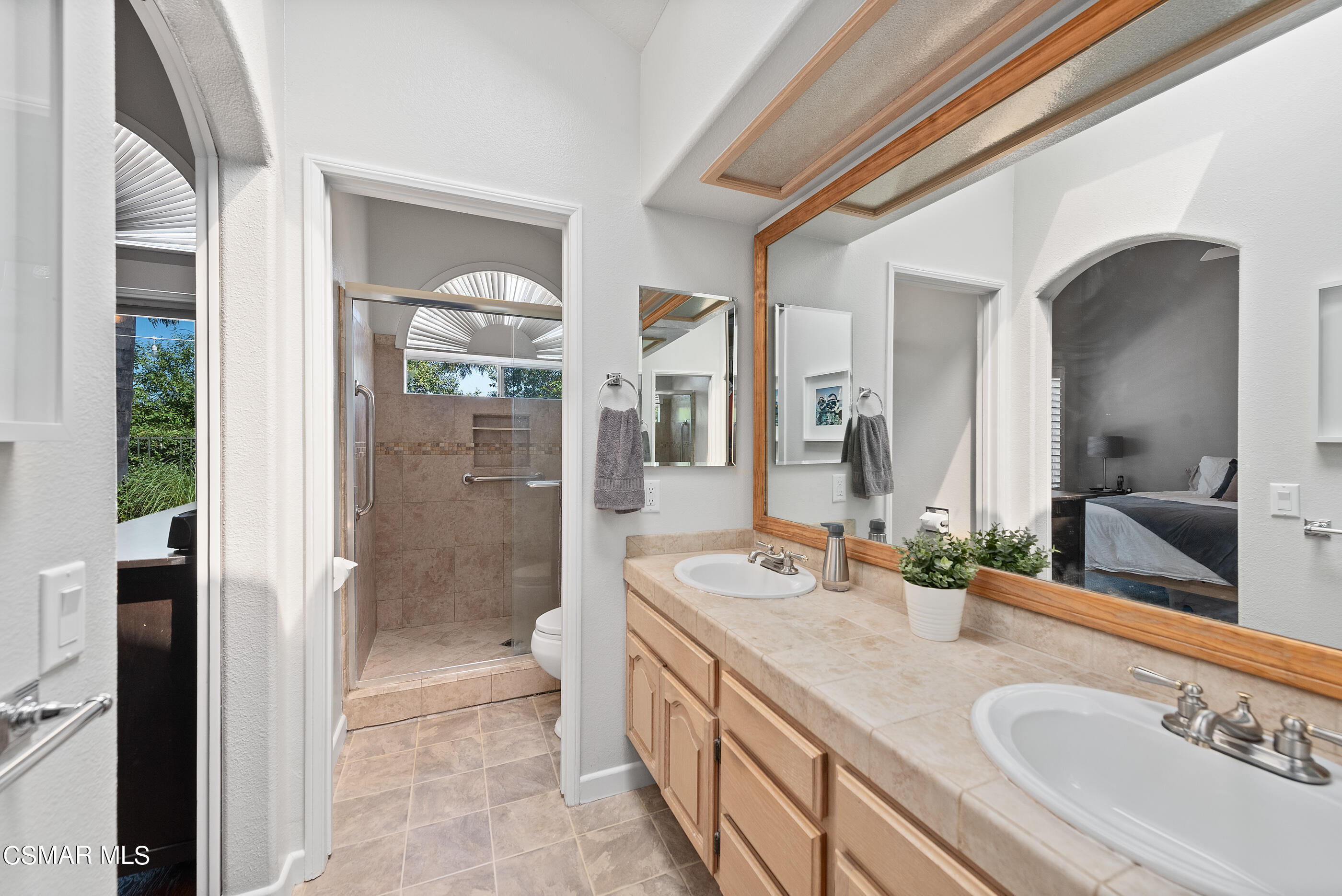 472 Fresh Meadows Road Simi Valley, CA 93065 - Photo 26 of 33 a bathroom with a granite countertop double vanity sink a mirror and a shower