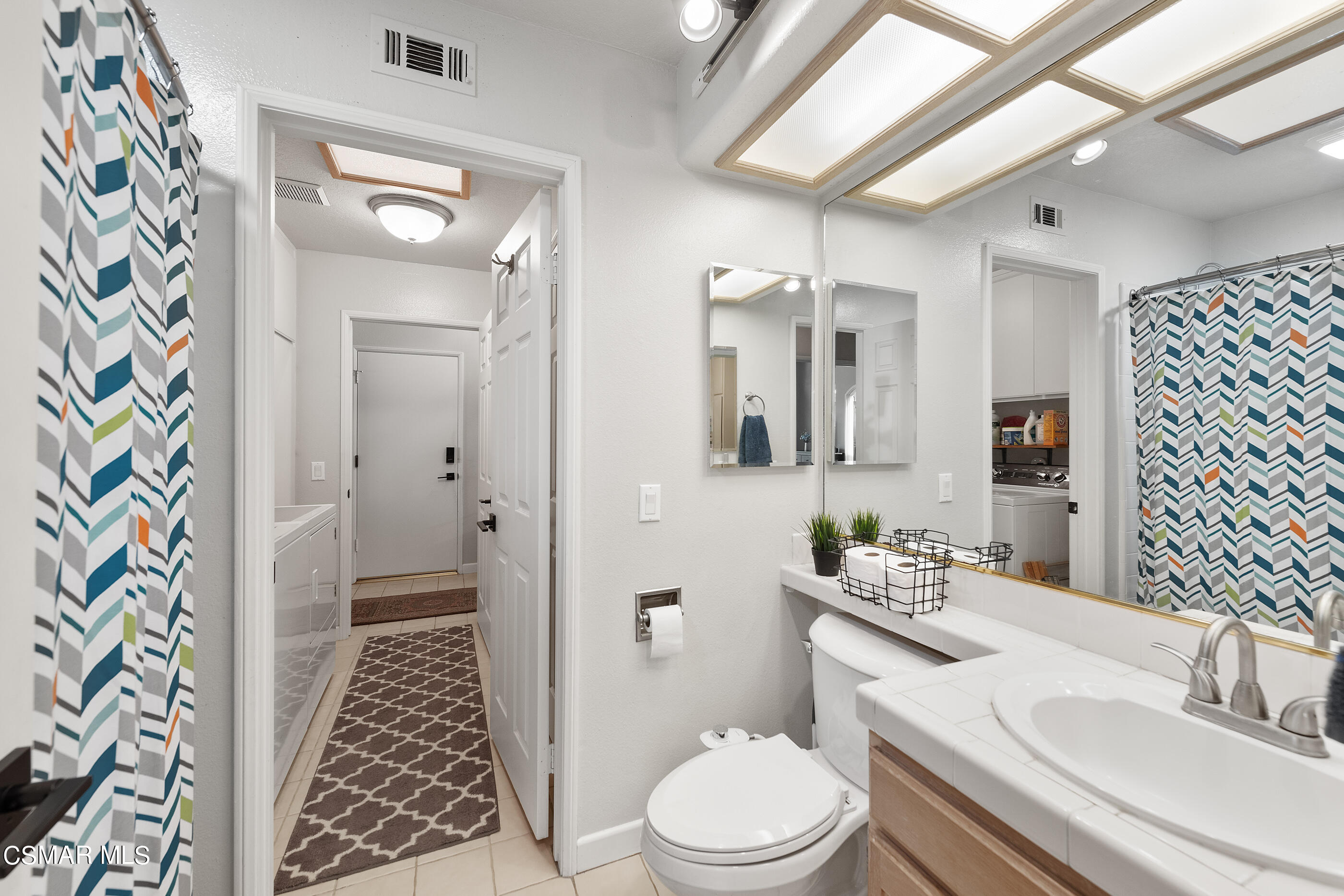 472 Fresh Meadows Road Simi Valley, CA 93065 - Photo 27 of 33 a bathroom with a sink a toilet a mirror a vanity and shower