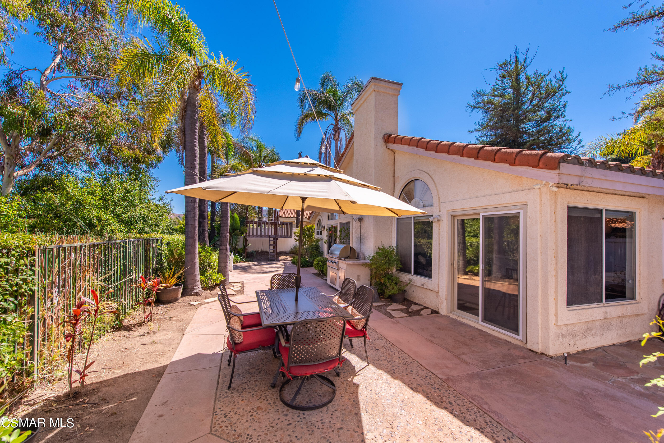 472 Fresh Meadows Road Simi Valley, CA 93065 - Photo 29 of 33 a patio with a table and chairs under an umbrella