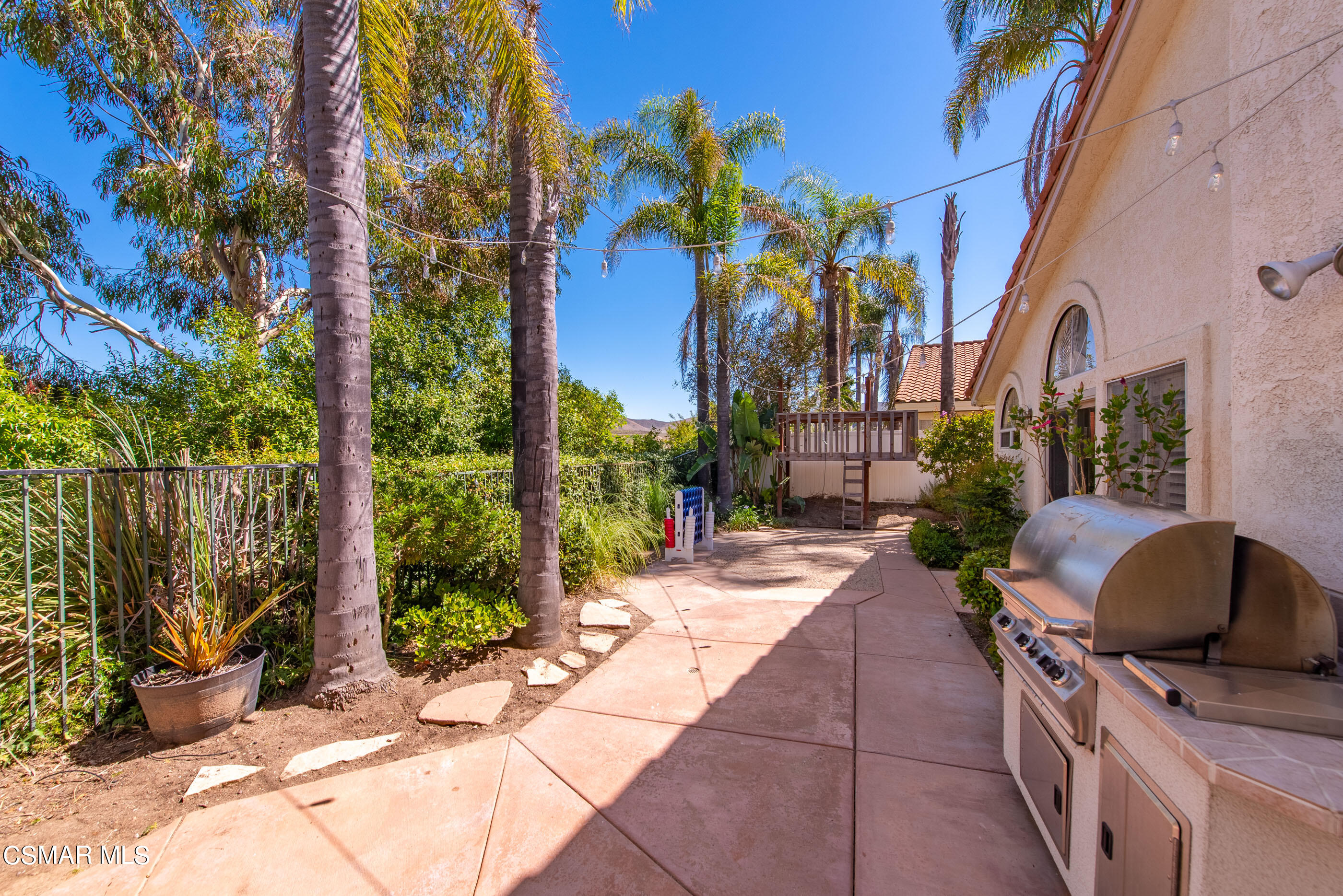 472 Fresh Meadows Road Simi Valley, CA 93065 - Photo 30 of 33 a view of backyard with wheel chair potted plants and wooden fence